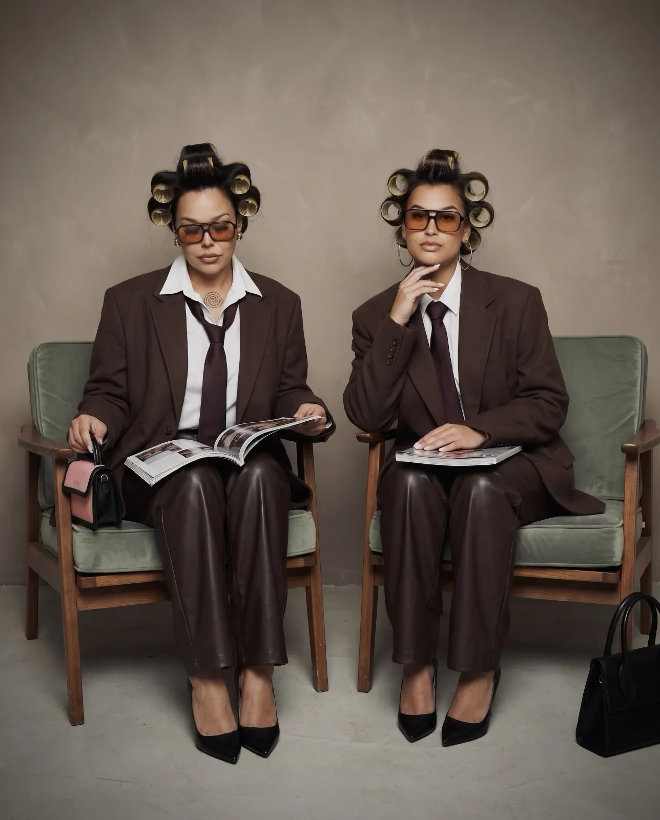 Two salon owners in rollers and suits reading magazines in a waiting room